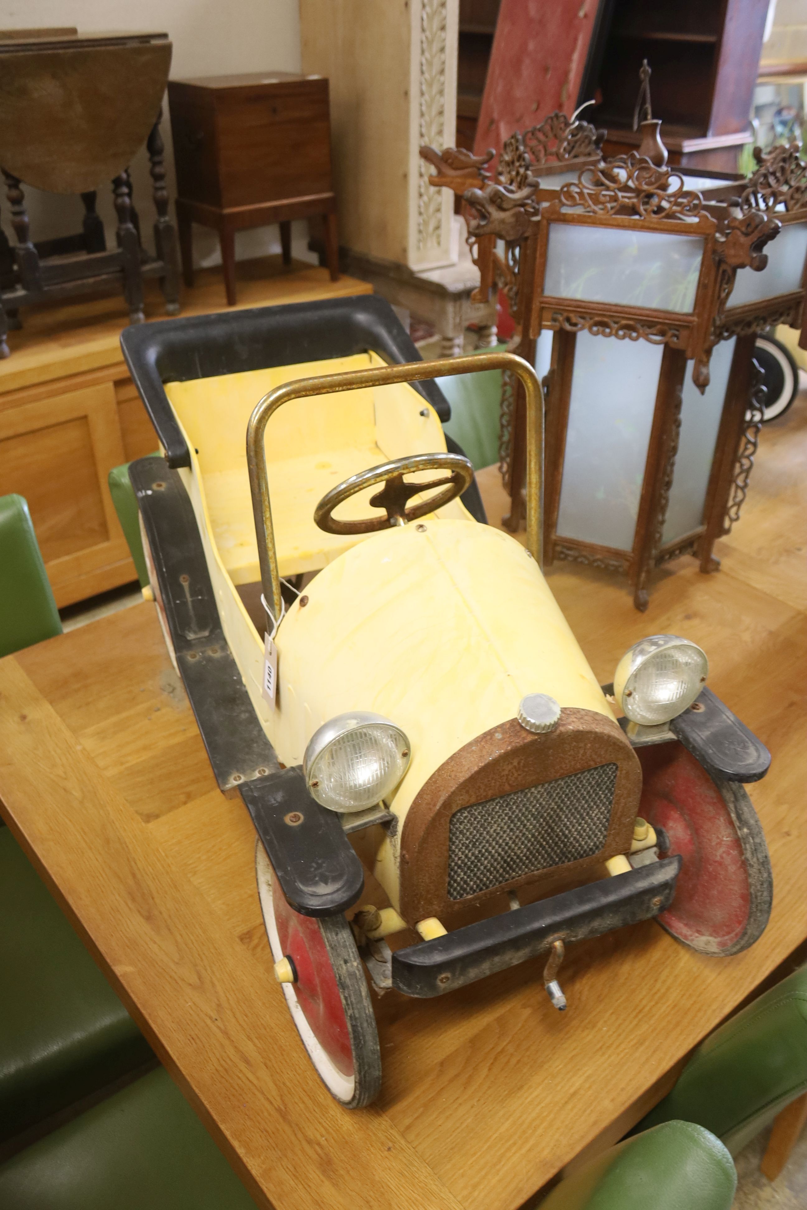 A child's tinplate pedal car, length 94cm